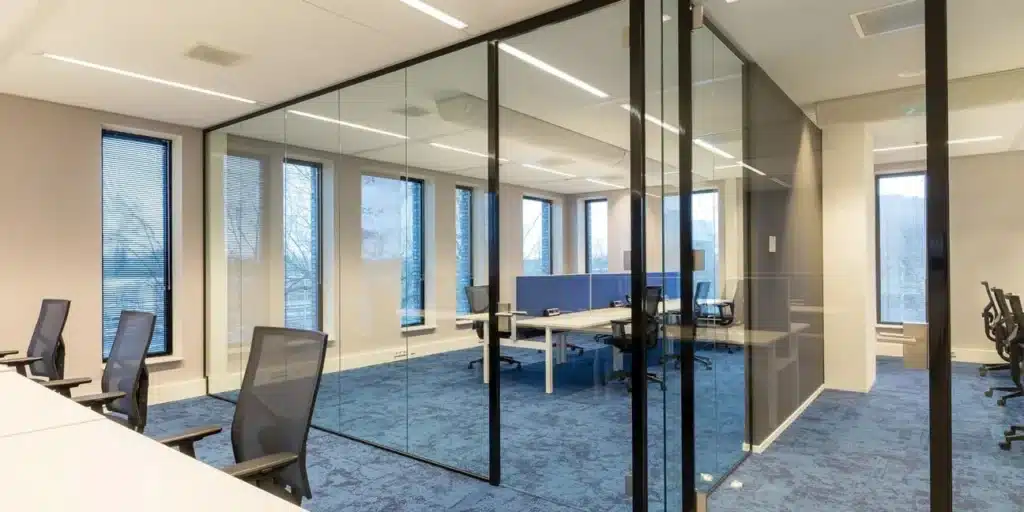 Modern kantoor met glazen wanden en vergaderruimte.